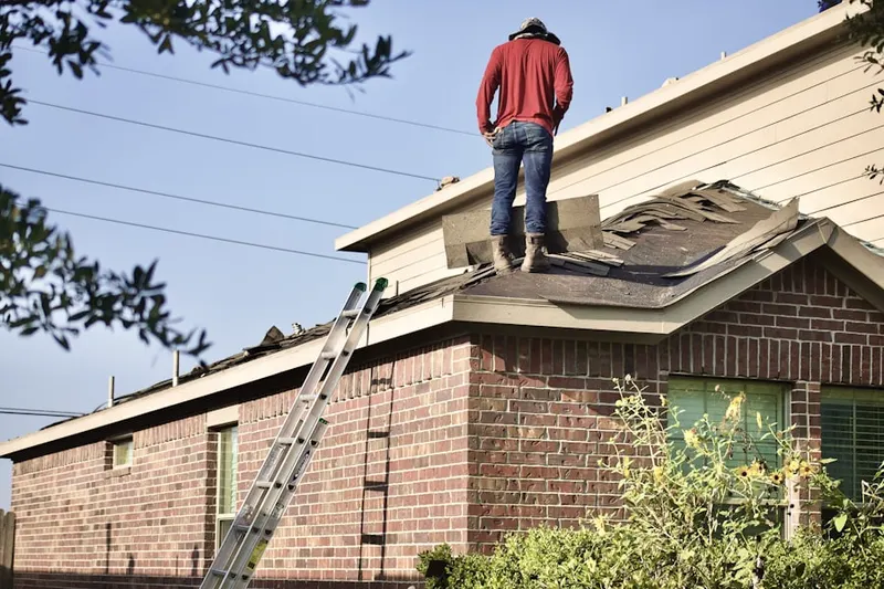 Professional roofer working on a residential roof in Reynolds